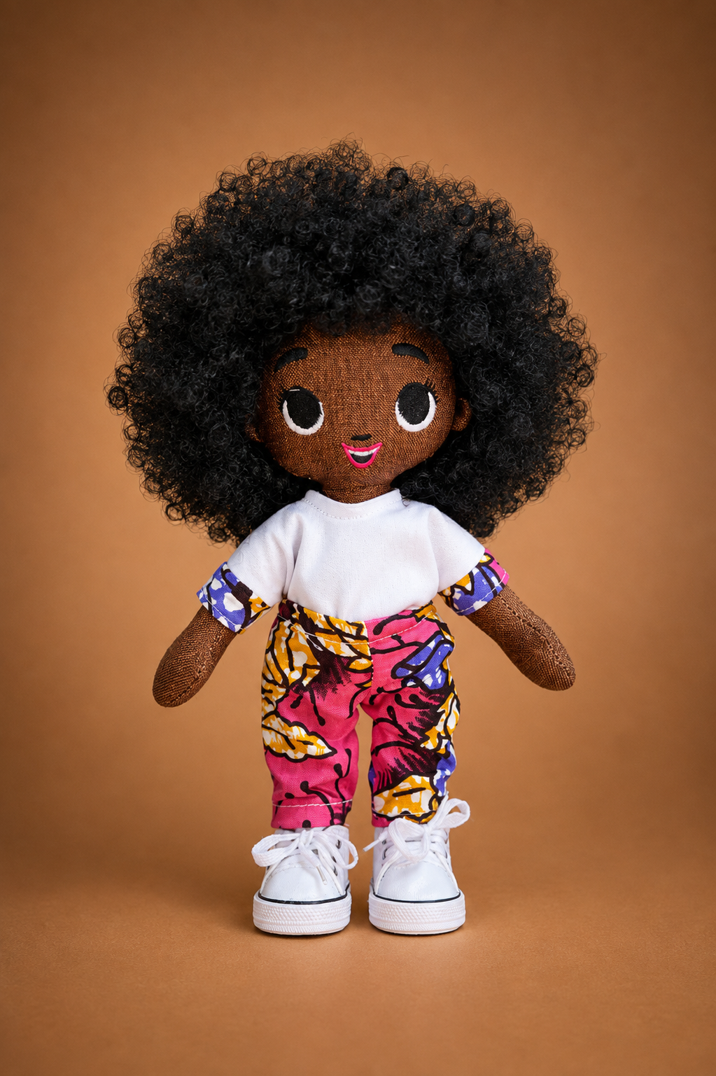 Tara doll wearing a bright pink African-print outfit